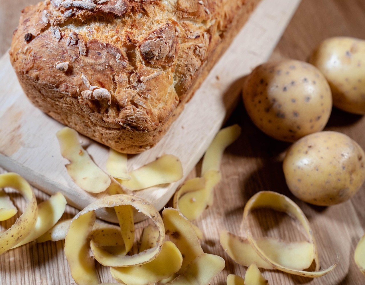 Bread loaf and potato peelings on a wooden board: agri-food residues used as bio-based feedstock in RUBBIO